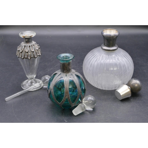 437 - A clear glass round bulbous thin necked scent bottle with stopper and silver neck, 15cm high, a gree... 