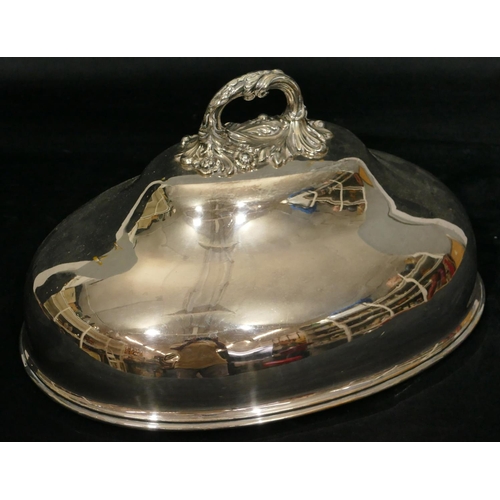 439 - An oval silver plated meat cover with centre carrying handle with engraved crest, 36cm diameter