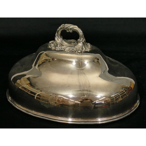 439 - An oval silver plated meat cover with centre carrying handle with engraved crest, 36cm diameter