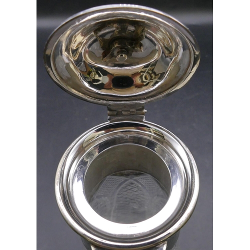 440 - A cut glass round decanter with silver plated neck, hinged lid and scroll handle, allover tooth cut ... 