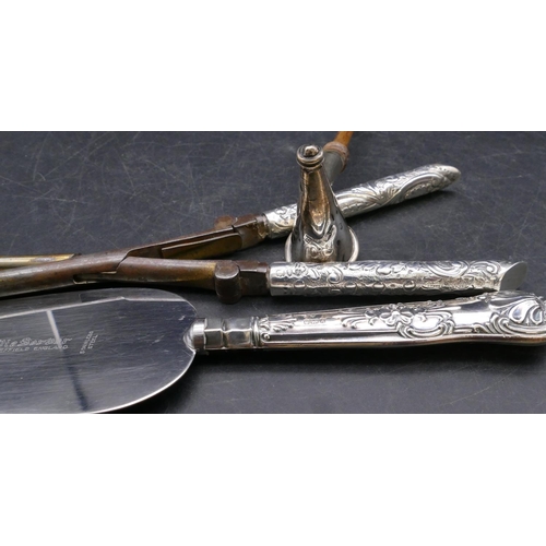 446 - A pair of Victorian silver handled curling tongs with hinged handles with embossed decoration, Londo... 