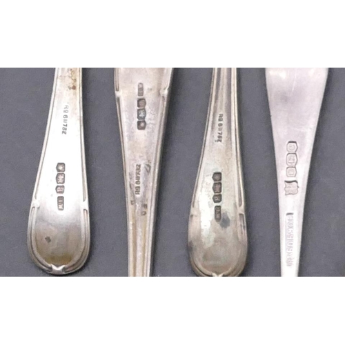 448 - A pair of Sheffield silver sugar tongs with engraved floral and leaf decoration and 4 odd Sheffield ... 