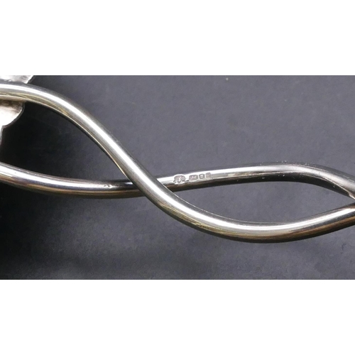 450 - A London silver spoon with raised branch shaped handle and embossed bowl, a similar London silver sp... 