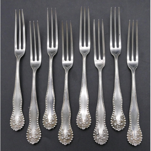 453 - A set of 8 Sterling silver small forks with embossed floral and ball rims, maker's mark G.M & Co, 2.... 