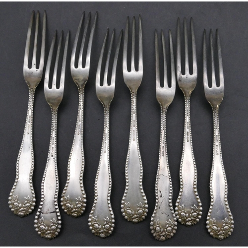 453 - A set of 8 Sterling silver small forks with embossed floral and ball rims, maker's mark G.M & Co, 2.... 