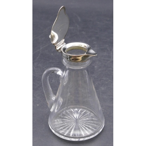 457 - A plain glass small Whisky jug with Birmingham silver hinged lid 