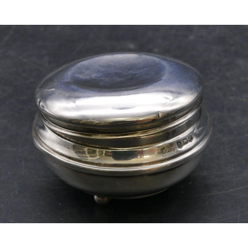 468 - A George V round bulbous silver trinket box with hinged lid enclosing velvet interior on 3 ball feet... 