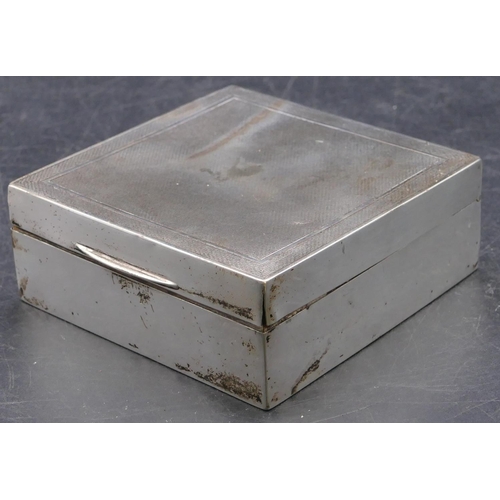 473 - A Birmingham square silver cigarette box with engine turned hinged lid enclosing cedar lined interio... 