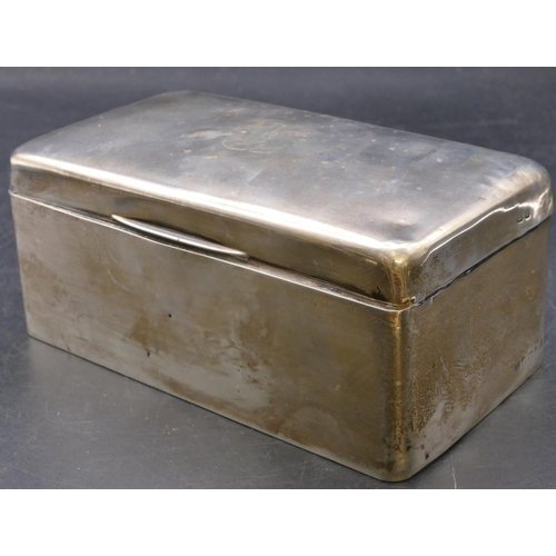 478 - A plain silver rectangular shaped cigarette box with hinged domed top enclosing cedar lined interior... 