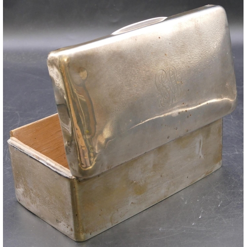 478 - A plain silver rectangular shaped cigarette box with hinged domed top enclosing cedar lined interior... 