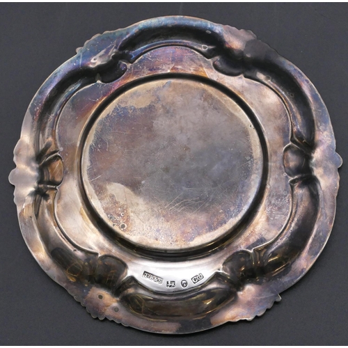 492 - A Victorian silver round scallop shaped dish with raised scroll and floral rim, Sheffield 1846, make... 