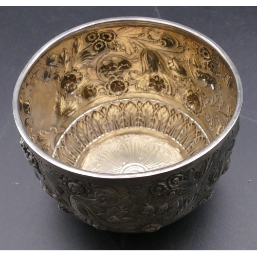 499 - A Victorian silver round sugar bowl with allover embossed floral, leaf and scroll decoration, London... 