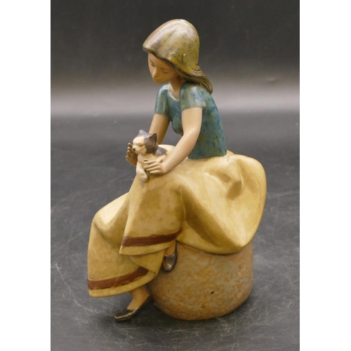 5 - A Lladro glazed earthenware figure of a seated lady with cat on her lap, 22cm high