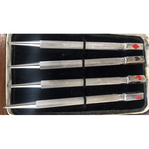 507 - A set of 4 Sterling silver bridge propelling pencils with engine turn decoration and enamelled card ... 