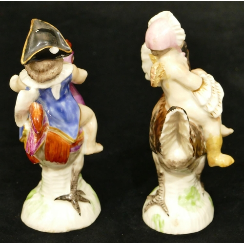 56 - A pair of Continental porcelain figures of Cupid seated on chickens (girl right foot and 1 wing rest... 