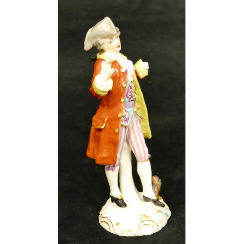 57 - A Continental porcelain figure of a standing gentleman in red coat (left hand missing, right hand re... 