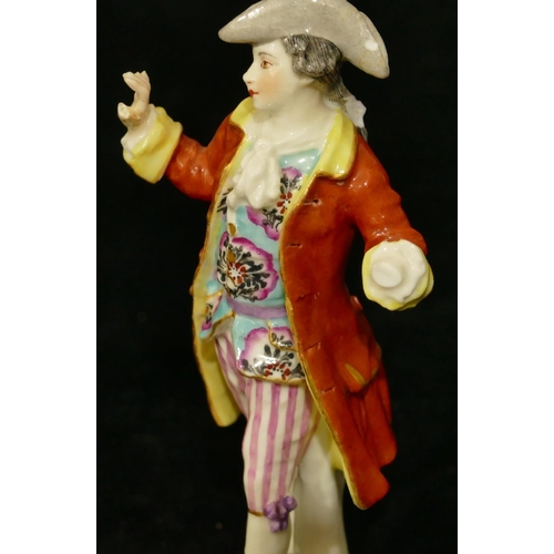 57 - A Continental porcelain figure of a standing gentleman in red coat (left hand missing, right hand re... 