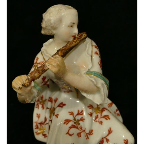 58 - A Continental porcelain figure of a seated lady playing a flute (both hands and flute restored, smal... 