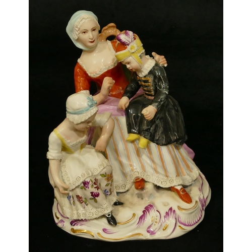 62 - A Vienna porcelain group of a seated lady with 2 children (lady's waist and girl in black dress arm ... 