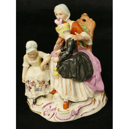 62 - A Vienna porcelain group of a seated lady with 2 children (lady's waist and girl in black dress arm ... 