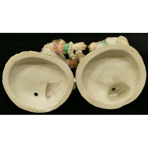 63 - A pair of Chelsea Derby porcelain figures of young gentleman and lady playing catch (both have branc... 