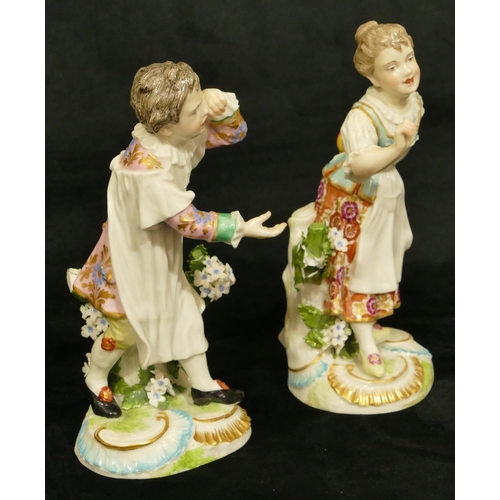 63 - A pair of Chelsea Derby porcelain figures of young gentleman and lady playing catch (both have branc... 