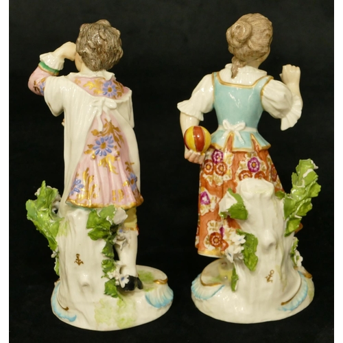 63 - A pair of Chelsea Derby porcelain figures of young gentleman and lady playing catch (both have branc... 