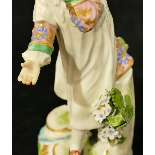 63 - A pair of Chelsea Derby porcelain figures of young gentleman and lady playing catch (both have branc... 