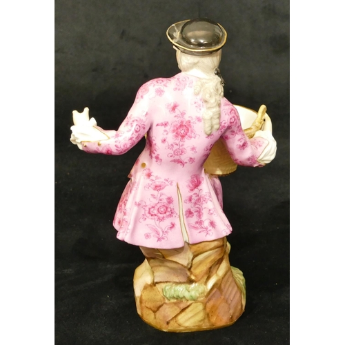 65 - A Meissen porcelain figure of a seated gentleman holding an oval basket (1 hand and thumb restored, ... 