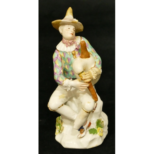 66 - A Meissen figure of a seated jester playing a bagpipe (hat, neck, left hand and right fingers, bagpi... 