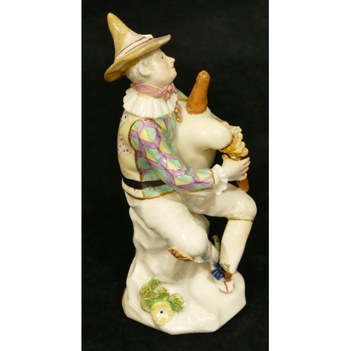 66 - A Meissen figure of a seated jester playing a bagpipe (hat, neck, left hand and right fingers, bagpi... 