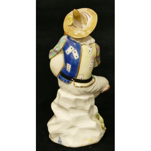 66 - A Meissen figure of a seated jester playing a bagpipe (hat, neck, left hand and right fingers, bagpi... 