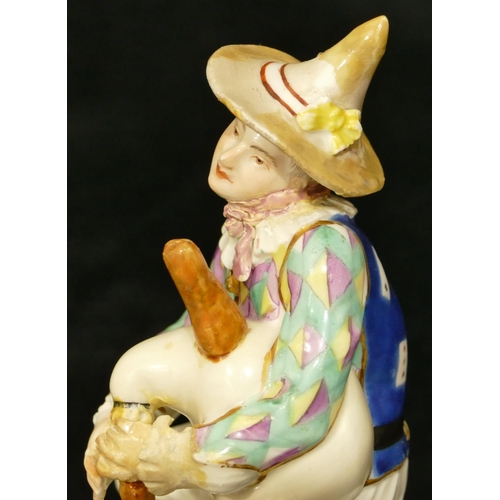 66 - A Meissen figure of a seated jester playing a bagpipe (hat, neck, left hand and right fingers, bagpi... 