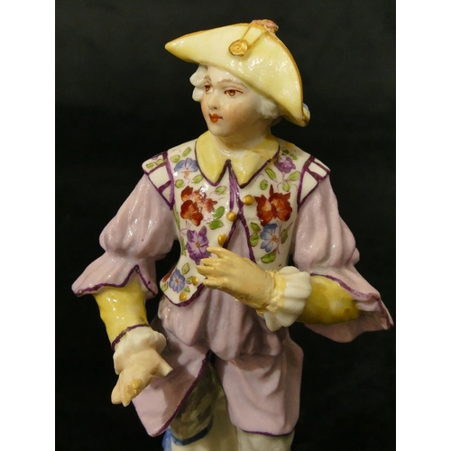 67 - A Meissen figure of a standing gentleman in puce jacket (plume to hat missing, chip to back of hat, ... 