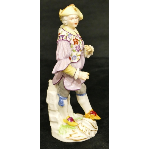 67 - A Meissen figure of a standing gentleman in puce jacket (plume to hat missing, chip to back of hat, ... 