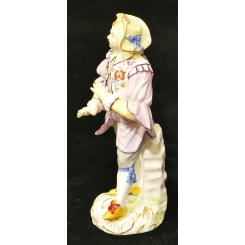 67 - A Meissen figure of a standing gentleman in puce jacket (plume to hat missing, chip to back of hat, ... 