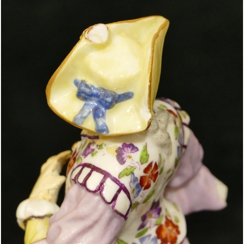 67 - A Meissen figure of a standing gentleman in puce jacket (plume to hat missing, chip to back of hat, ... 