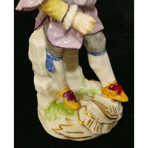 67 - A Meissen figure of a standing gentleman in puce jacket (plume to hat missing, chip to back of hat, ... 