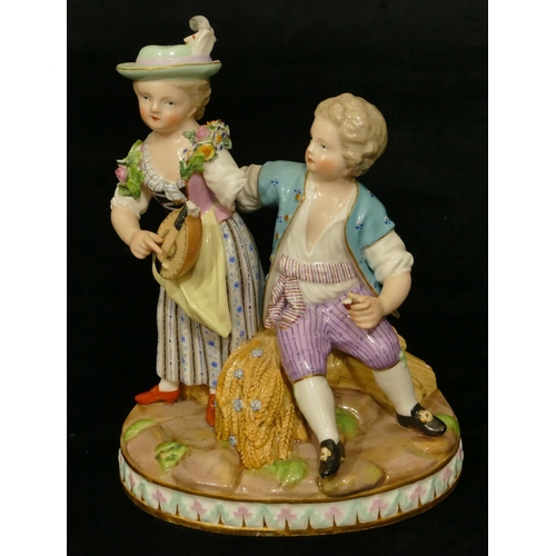 68 - A Meissen group of seated boy and standing girl playing mandolin (part to plumage, end to mandolin, ... 