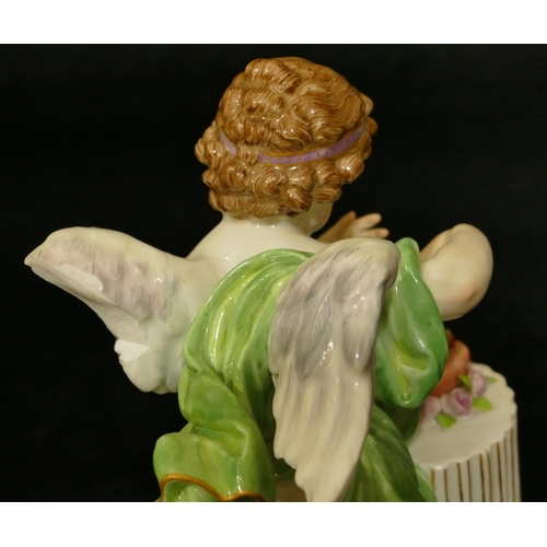 70 - A Meissen figure of Cupid standing next to a pedestal (part wing missing, chip to underside of base)... 