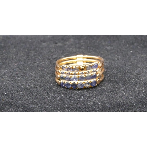 719 - A lady's ring in the form of 4 rings, each set with 6 sapphires (1 missing), size O, 4.7 grams gross