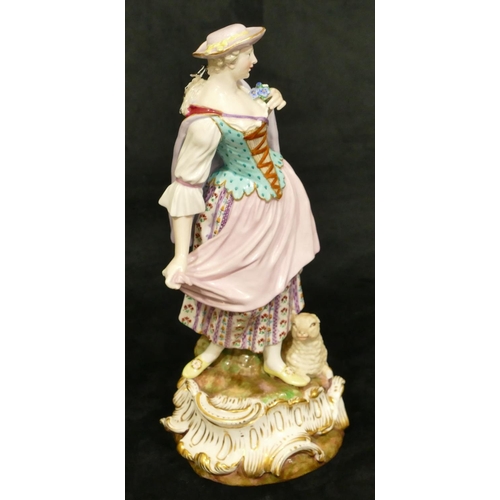 72 - A Meissen figure of a standing lady with sheep at her feet (part tree stump, lamb's left hoof and le... 