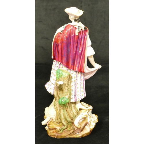 72 - A Meissen figure of a standing lady with sheep at her feet (part tree stump, lamb's left hoof and le... 