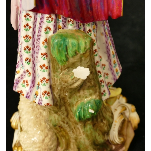 72 - A Meissen figure of a standing lady with sheep at her feet (part tree stump, lamb's left hoof and le... 