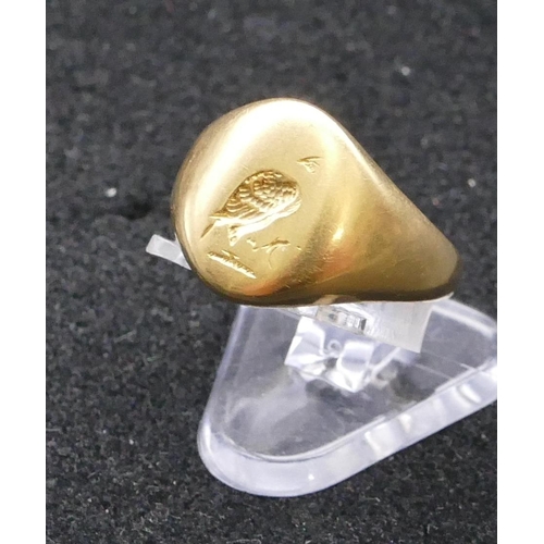 732 - A high carat gold signet ring with part engraved crest, size M/N, 7.2 grams