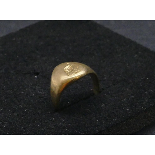 732 - A high carat gold signet ring with part engraved crest, size M/N, 7.2 grams