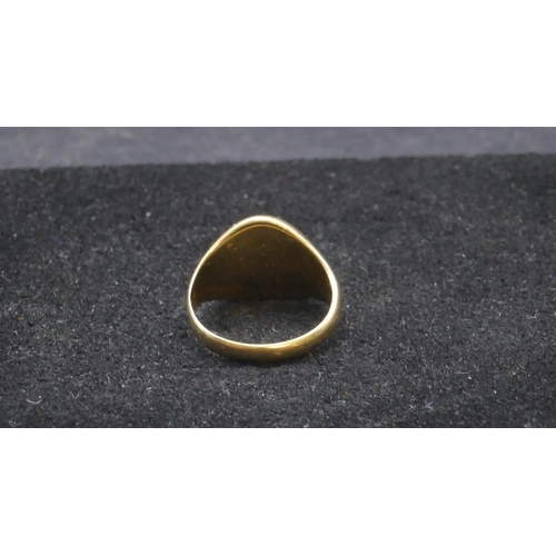 732 - A high carat gold signet ring with part engraved crest, size M/N, 7.2 grams