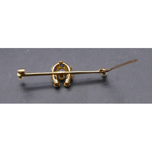 733 - A 15ct gold bar brooch with horseshoe centre inset with 7 sapphires and interspersed by 6 small diam... 