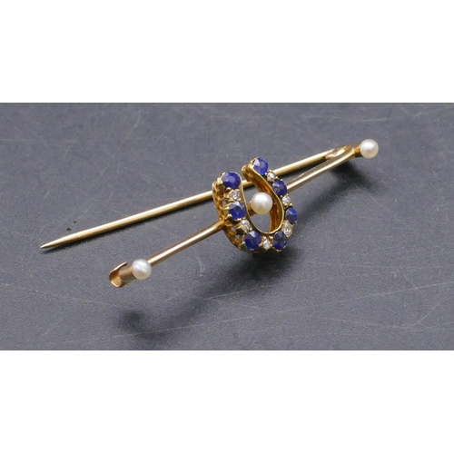 733 - A 15ct gold bar brooch with horseshoe centre inset with 7 sapphires and interspersed by 6 small diam... 