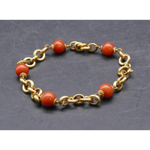 734 - An 18ct gold and coral bead bracelet, 20cm long, 7.9 grams gross